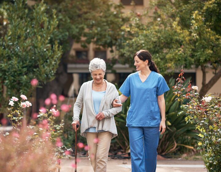 A staff member walks outside with a resident